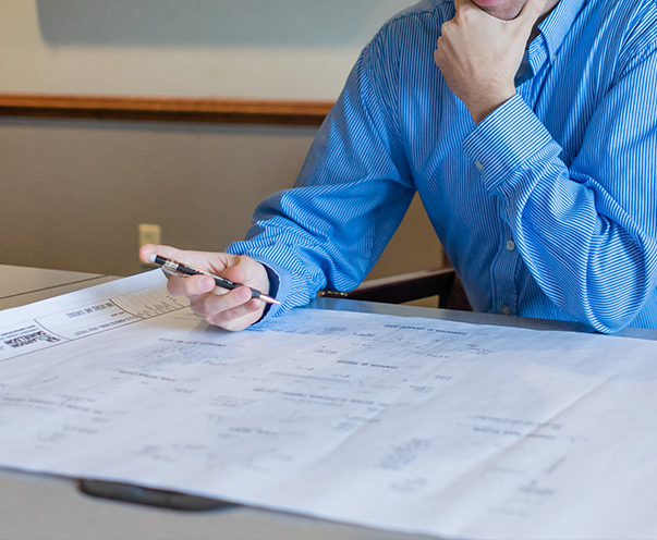 A project manager reviews drawings during the design/build process.