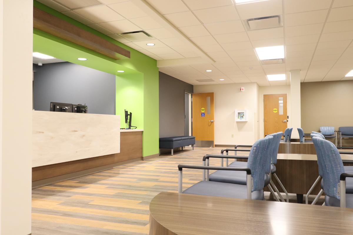 HealthLinc-2025_fullwidth The new lobby at HealthLinc's Mishawaka Clinic, completed in 2025, features standard HealthLinc design elements including a white marble desk with a wooden overhand and green walls
