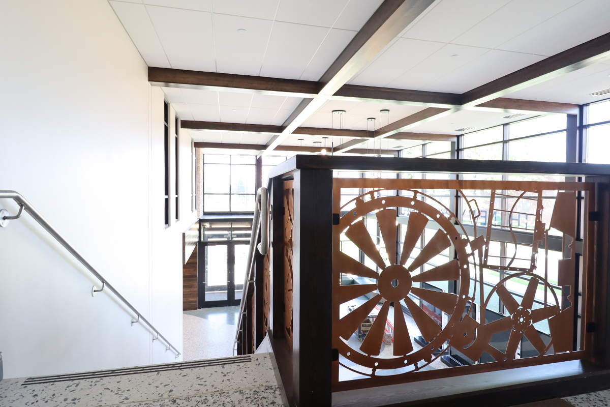 NYB Office_fullwidth a stair railing features panels celebrating New York Blower's array of products