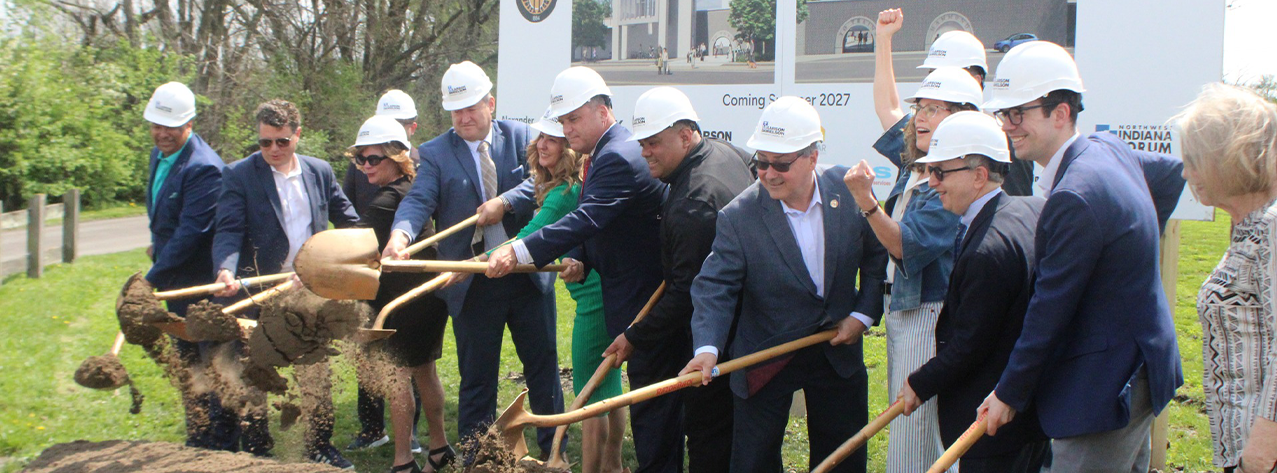 A group of officials ceremonially shovel the first scoops of dirt at the downtown Hammond Train Station