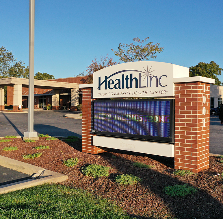 Healthcare sign in front of a healthcare building