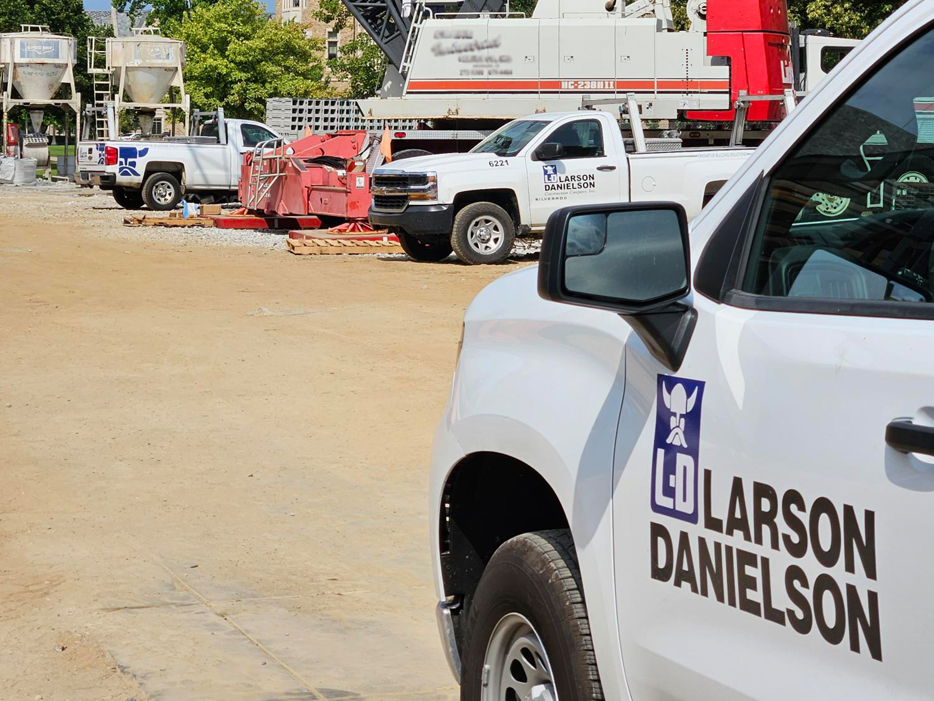 Larson-Danielson trucks parked at a jobsite